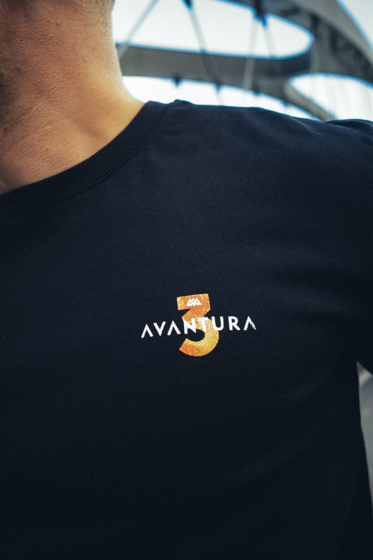Detailaufnahme des Avatura Logos am Ärmelbund des T-Shirts