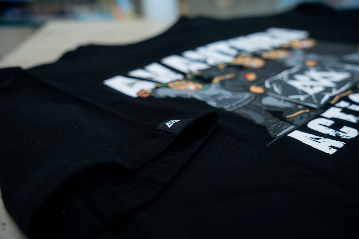 Macro shot of woven mountain logo tag and fabric texture on black T-shirt sleeve