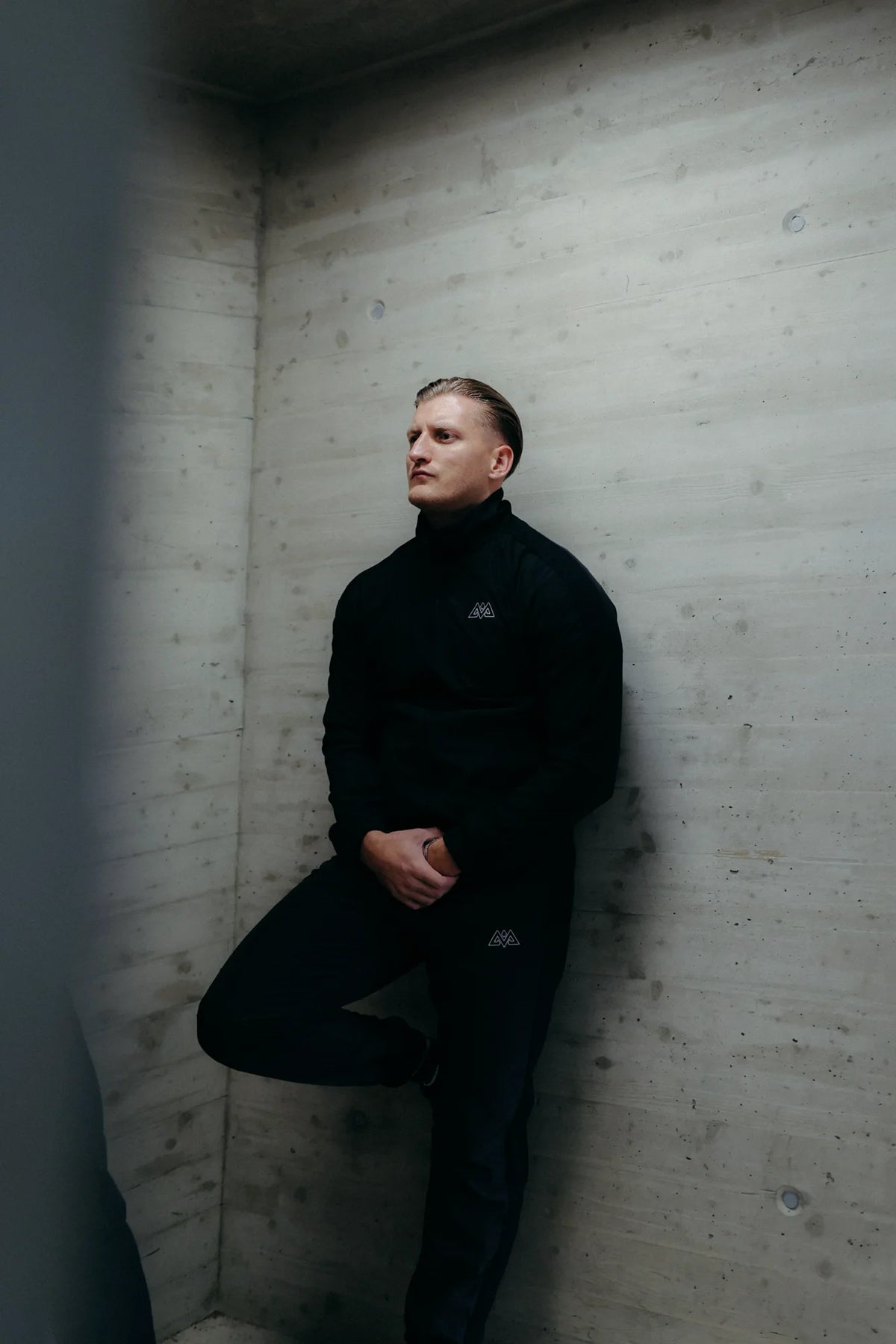 Black high-neck tracksuit jacket and pants with embroidered logos