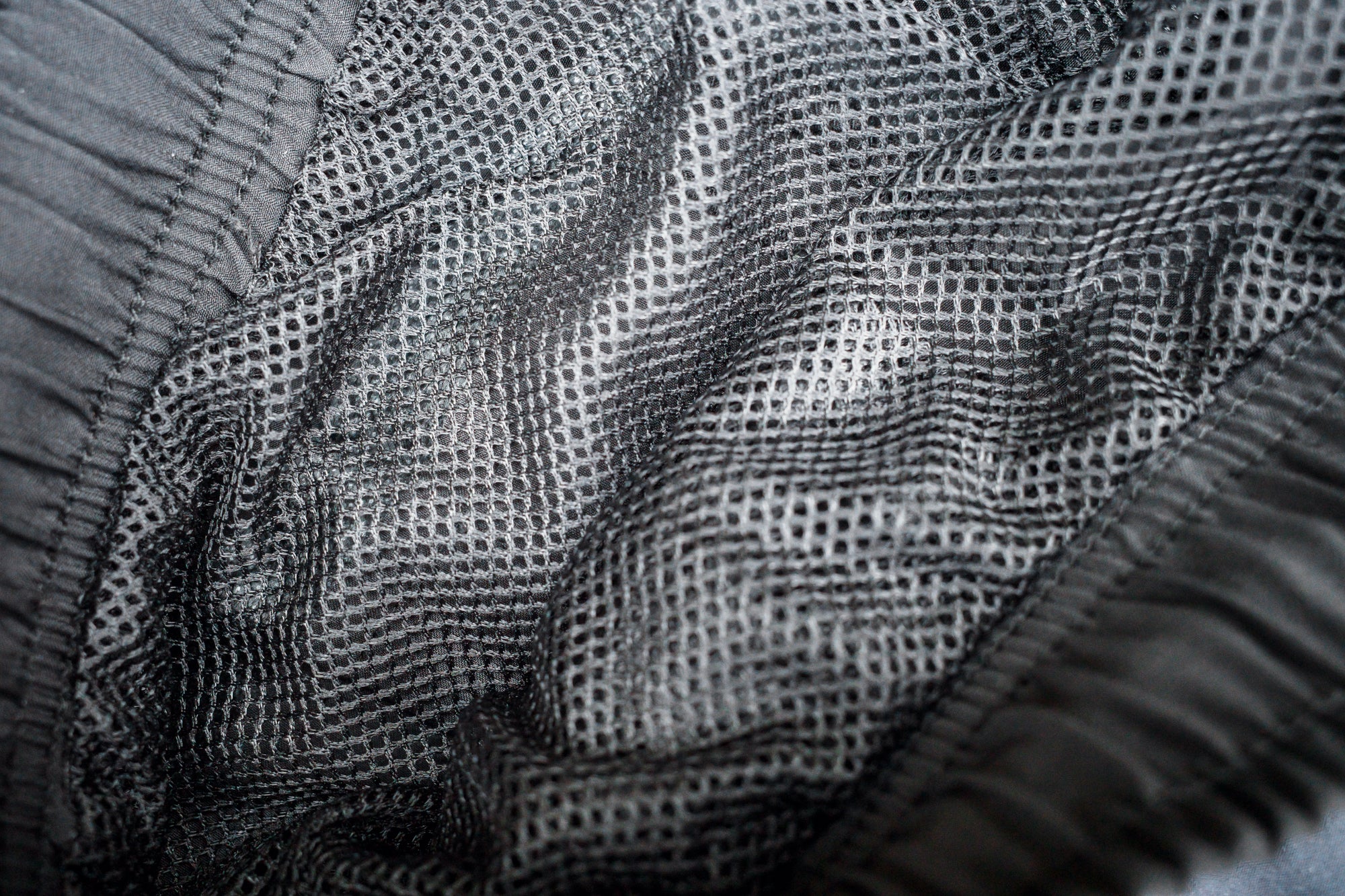 Black mesh netting insert lining detail in swim shorts