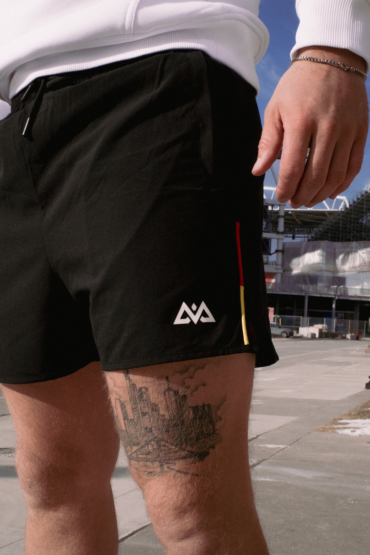 Detail of the rear pocket of black shorts with zipper and logo