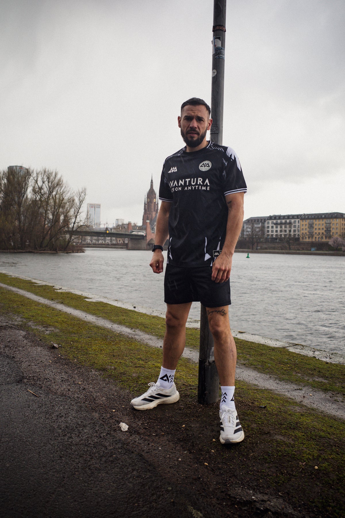 Full view of black Avantura jersey with large front text print