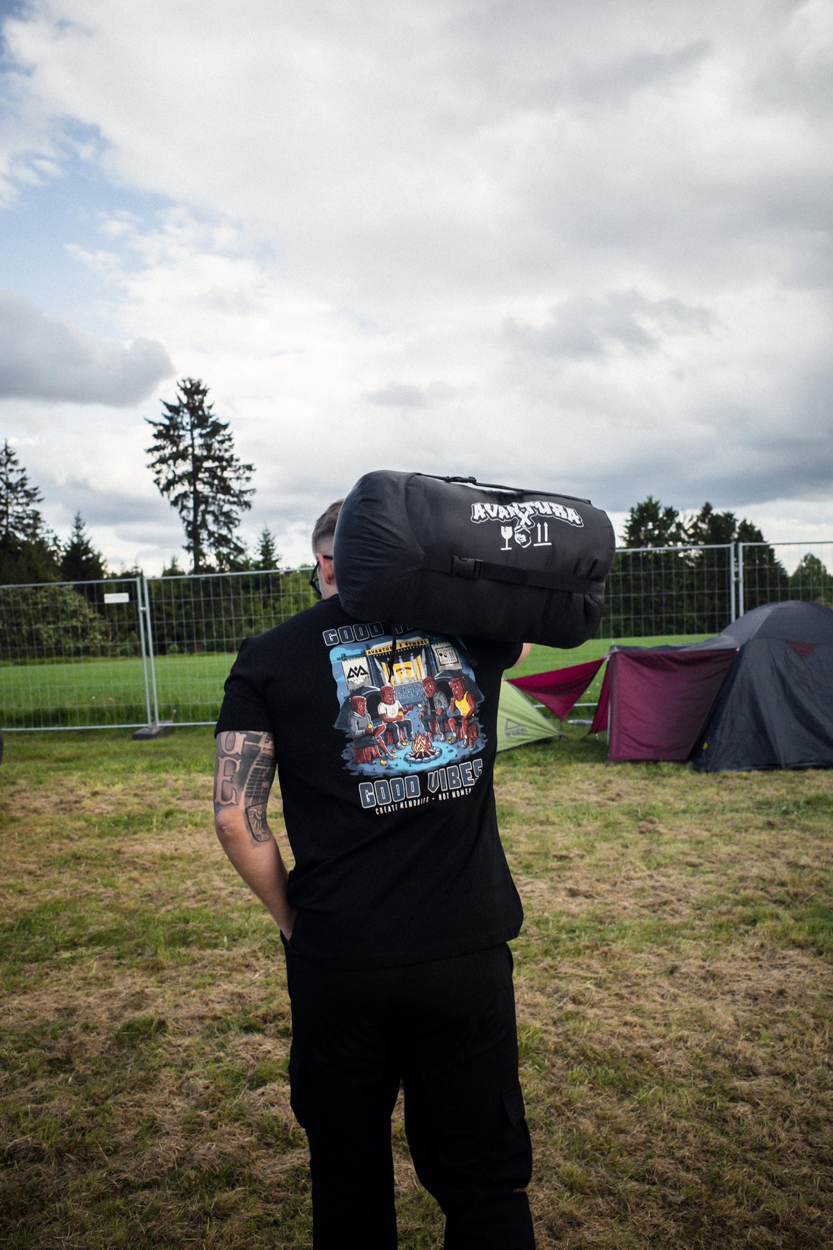 Rear view of black Avantura T-shirt with 'Good Vibes' back print and logo sack
