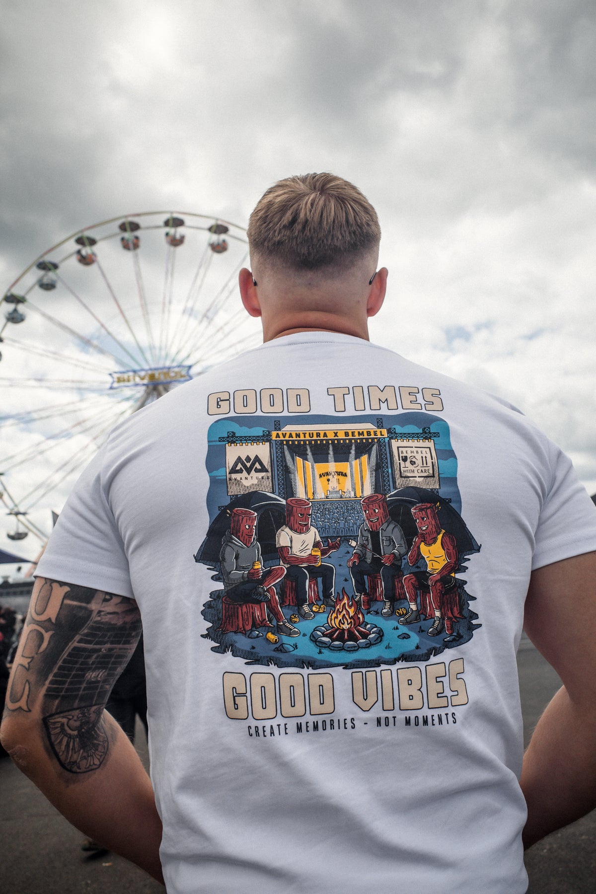 Rear view of white t-shirt displaying 'Avantura x Bembel' stage art