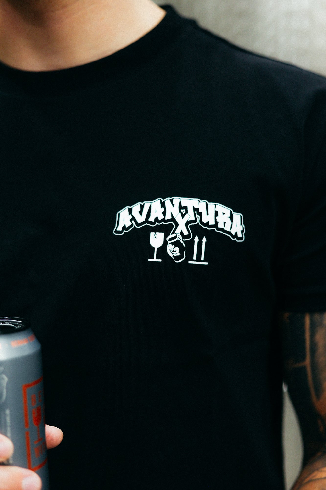 Avantura x Bembel black t-shirt chest logo and icons close-up