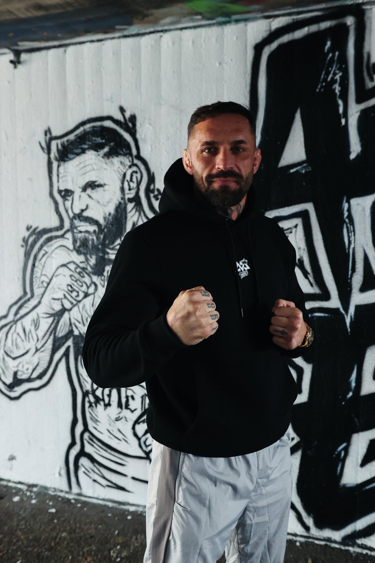 Front view of black Avanta hoodie featuring centered white logo on chest