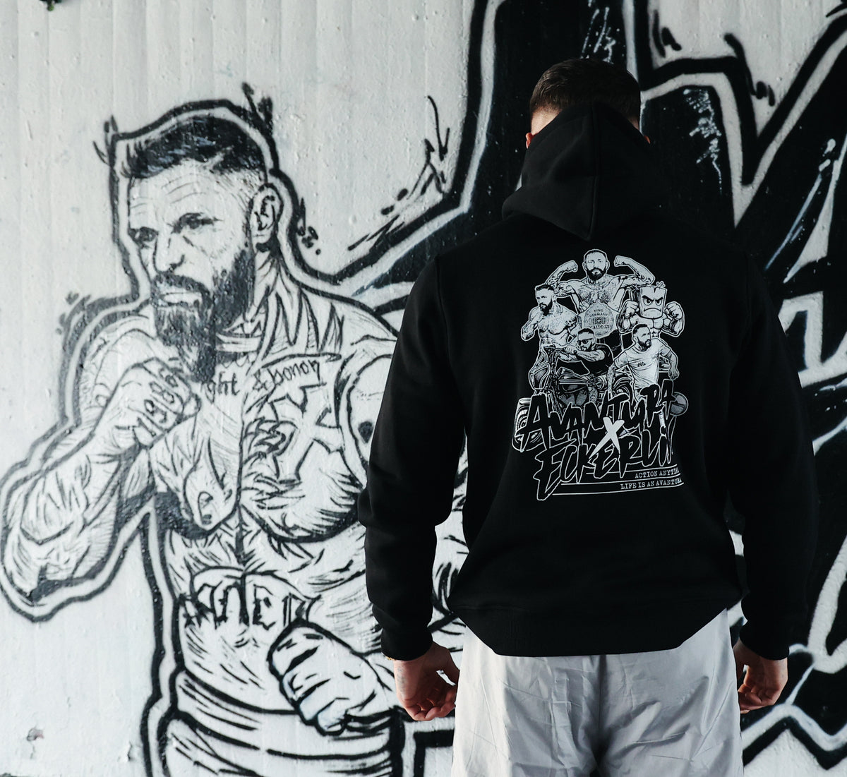 Black Avantura hoodie with large back graphic print and 'Avantura Forever' text