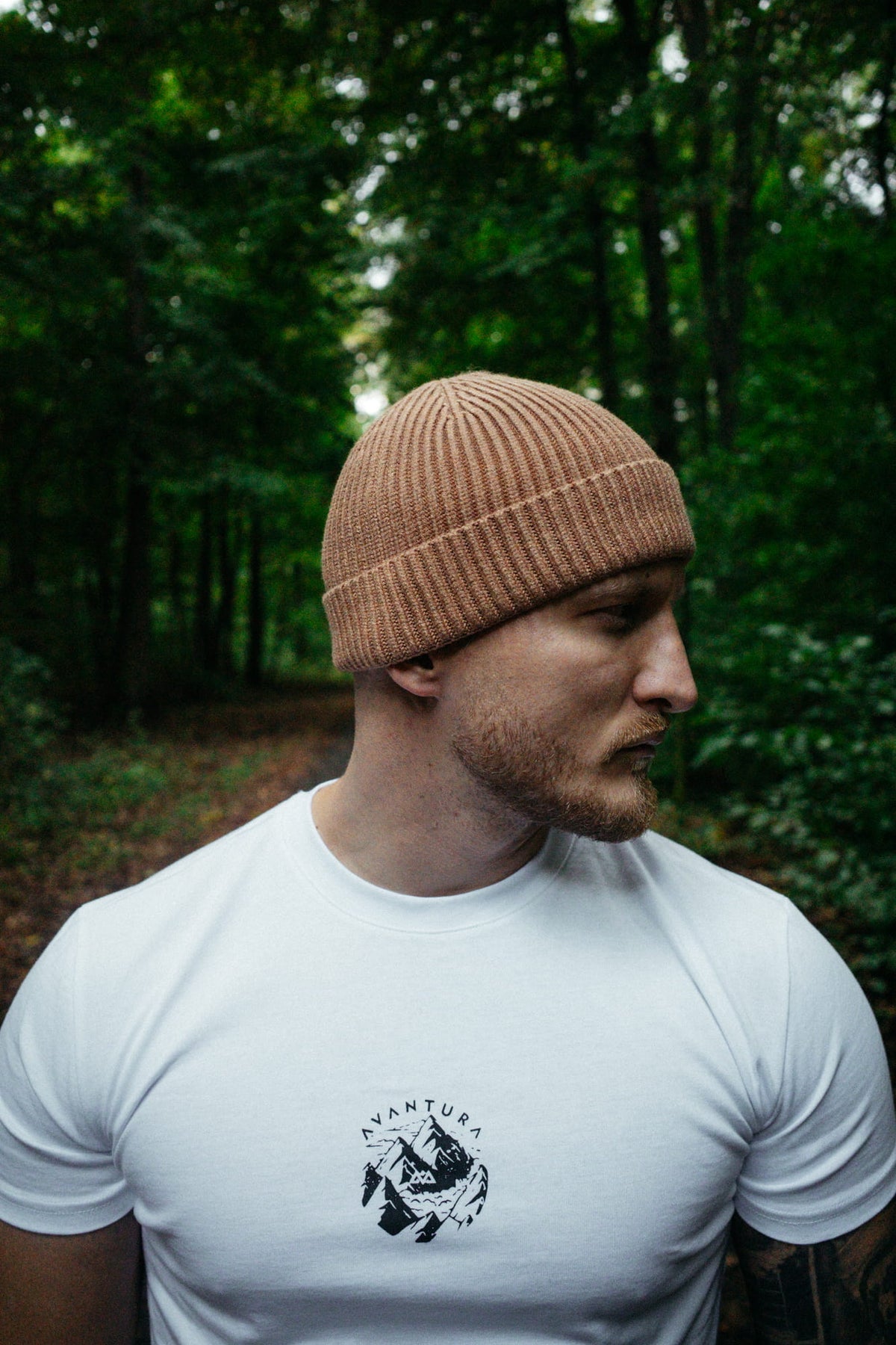 Man wearing beige Avantura Beanie in forest during daylight