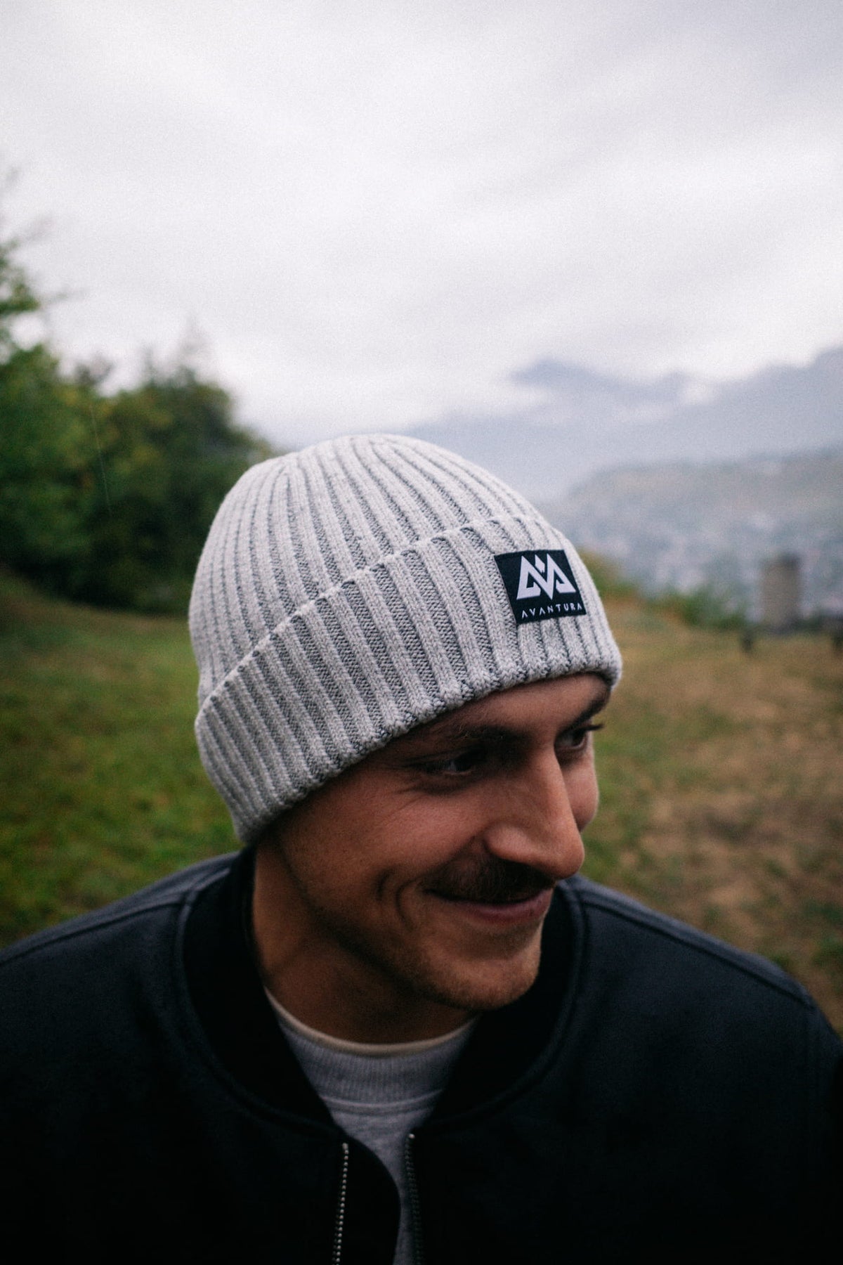 Man wearing light gray beanie in outdoor setting