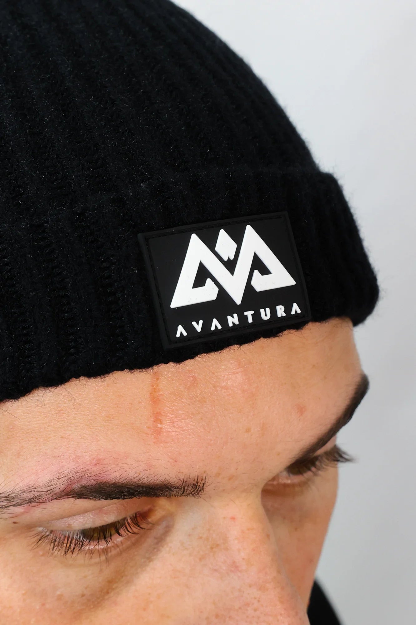 Close-up of black beanie rubber patch detail