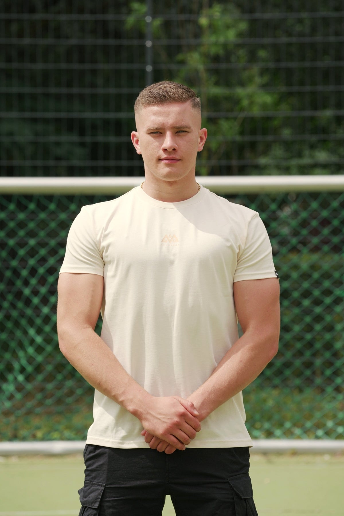 Men's pastel peach crew neck t-shirt with subtle chest logo