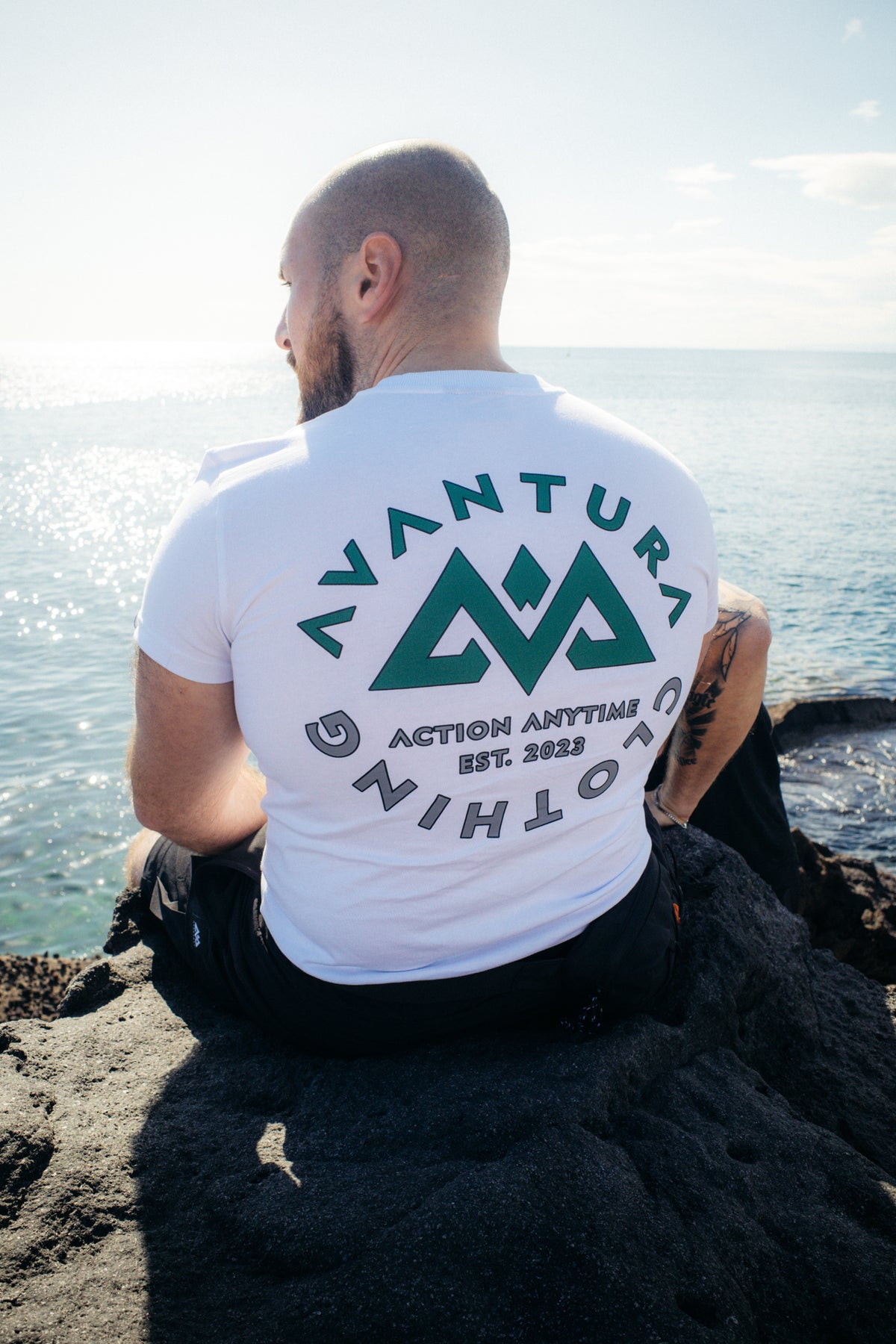 Close-up of white t-shirt back print featuring arched brand text
