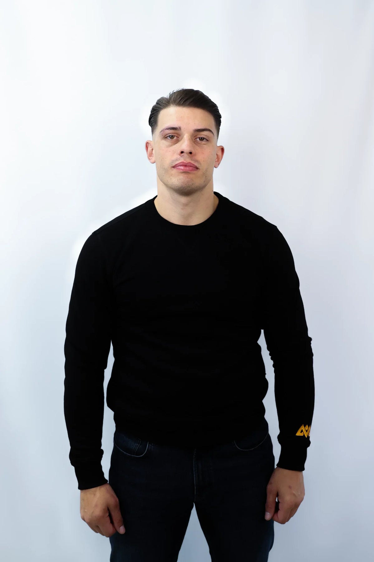 Front view of men's black crewneck sweater with sleeve detail