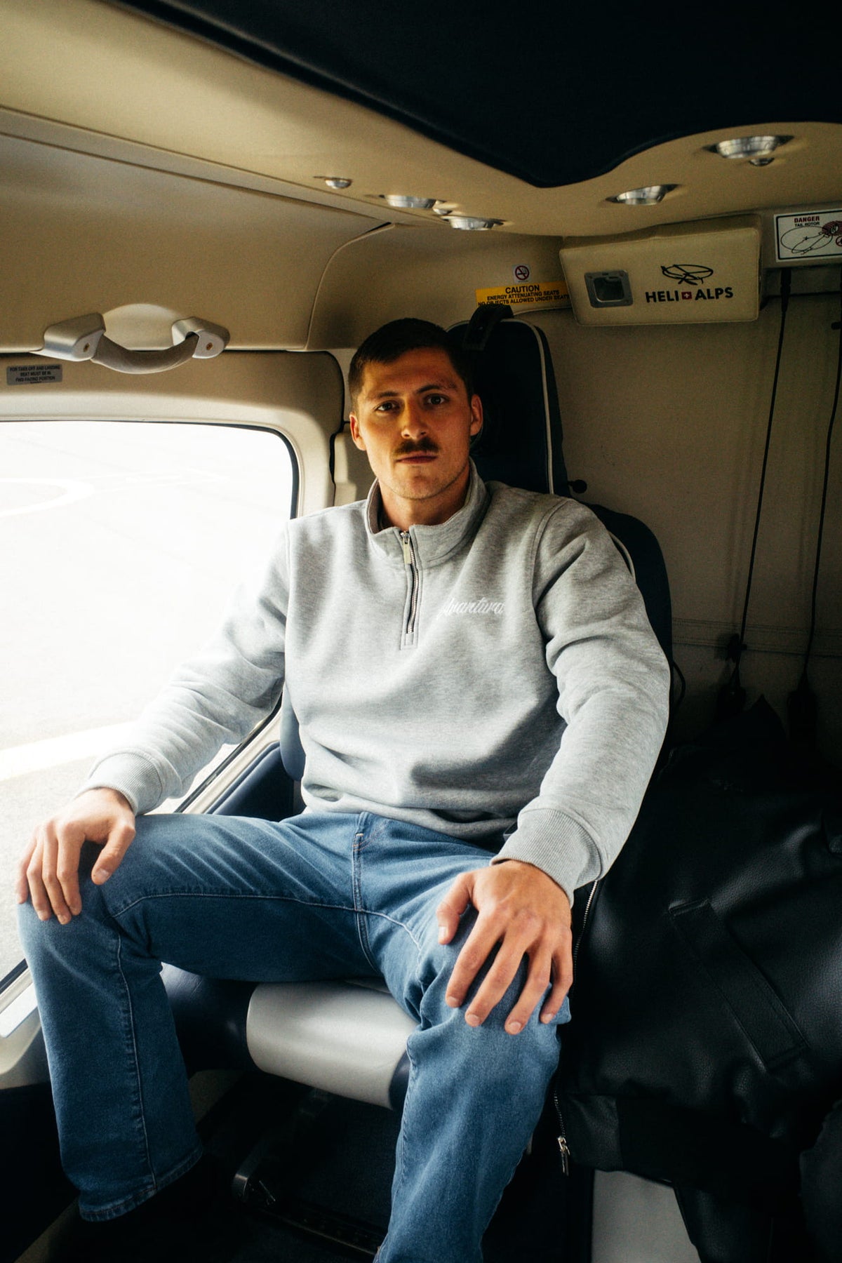 Light gray half-zip sweater with white text inside a helicopter