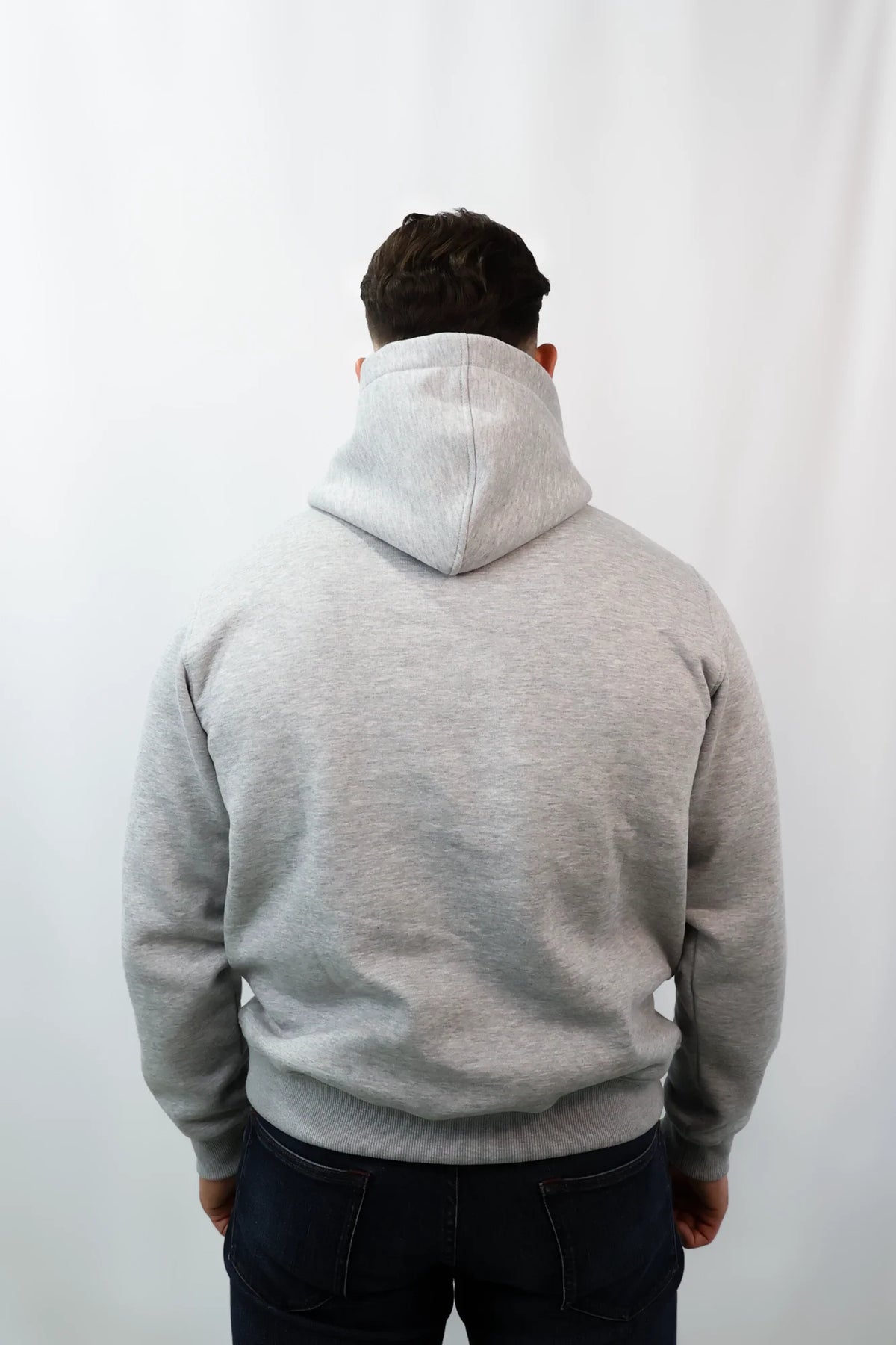 Back view of plain heather grey hoodie with ribbed hem