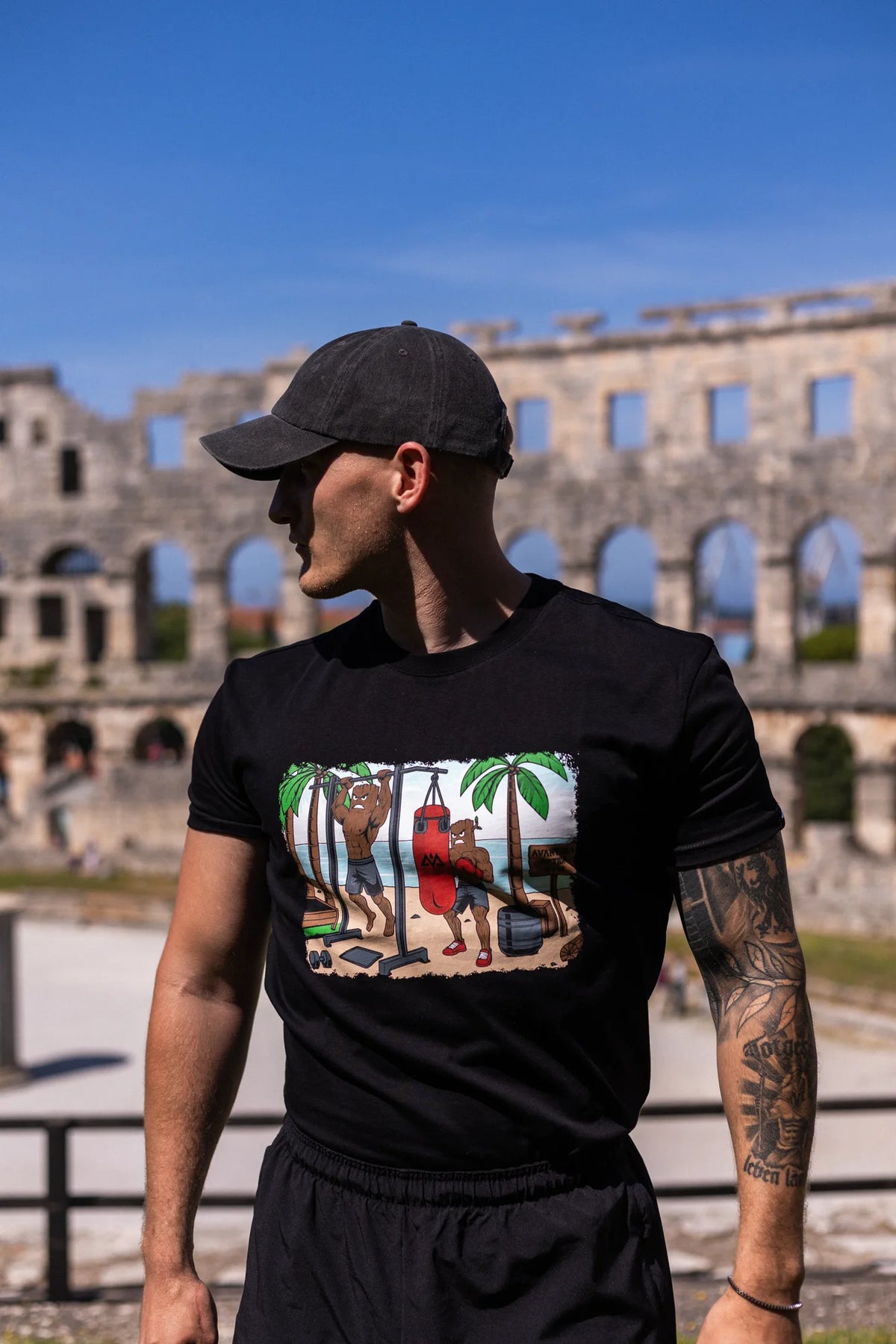 Side view of black T-shirt with colorful Groot training print