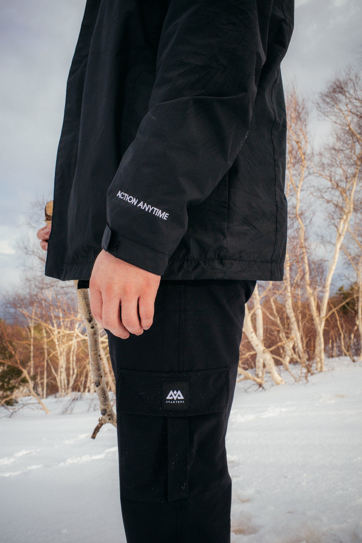 Black DRY ACTION REGENJACKE 2.0 with 'ACTION ANYTIME' sleeve embroidery in snow