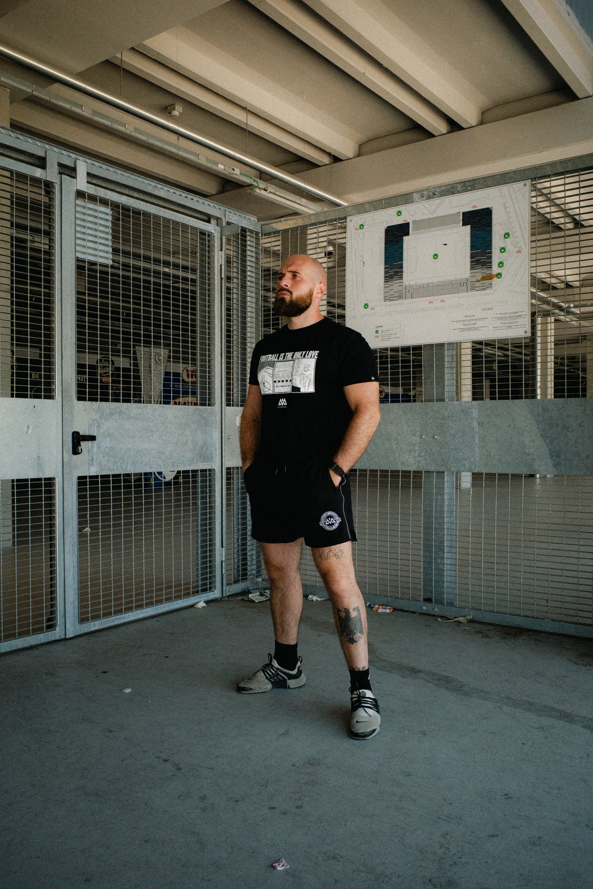 Full body look at black football graphic T-shirt and shorts