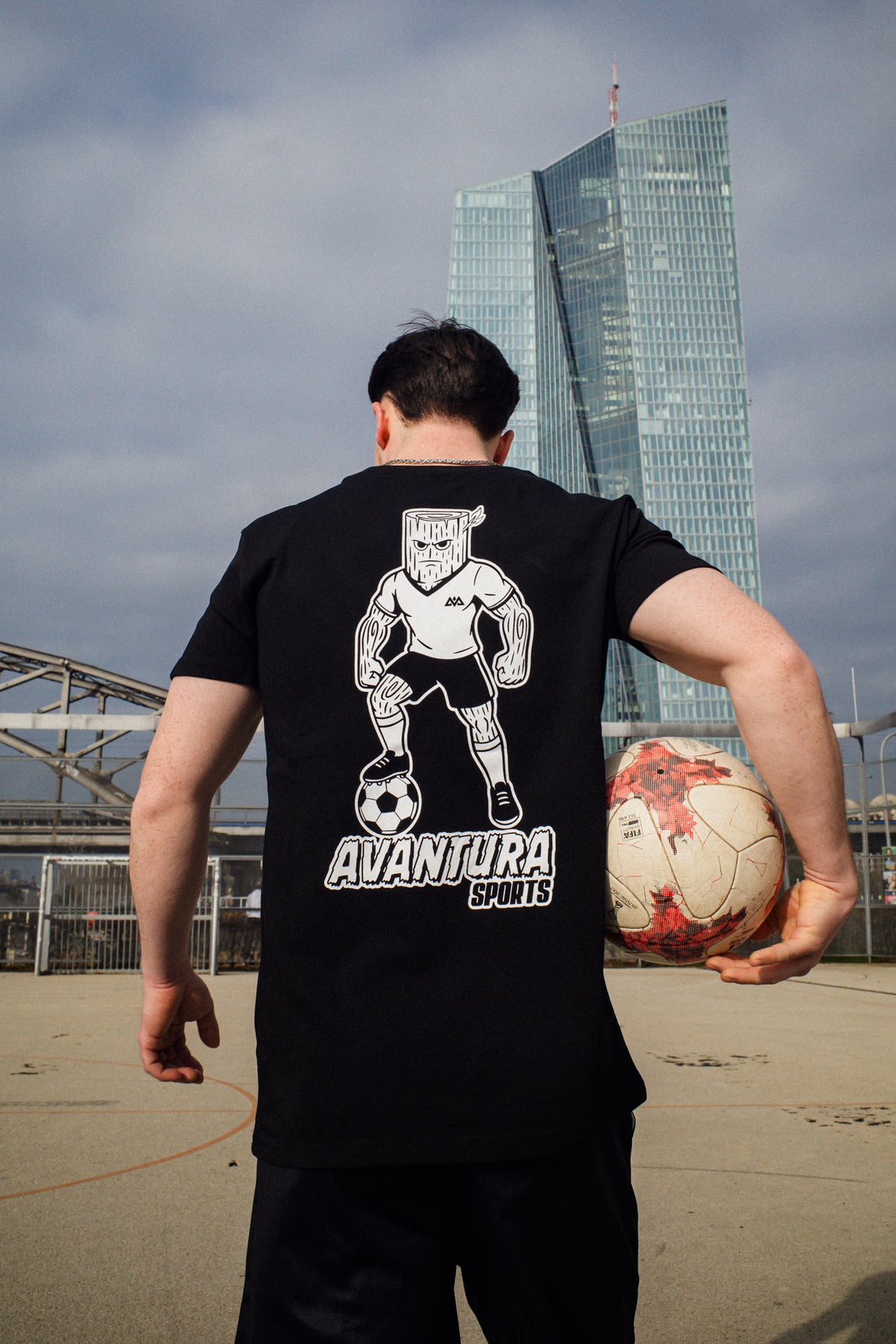 Urban street style black T-shirt with stylized log-headed soccer player back design