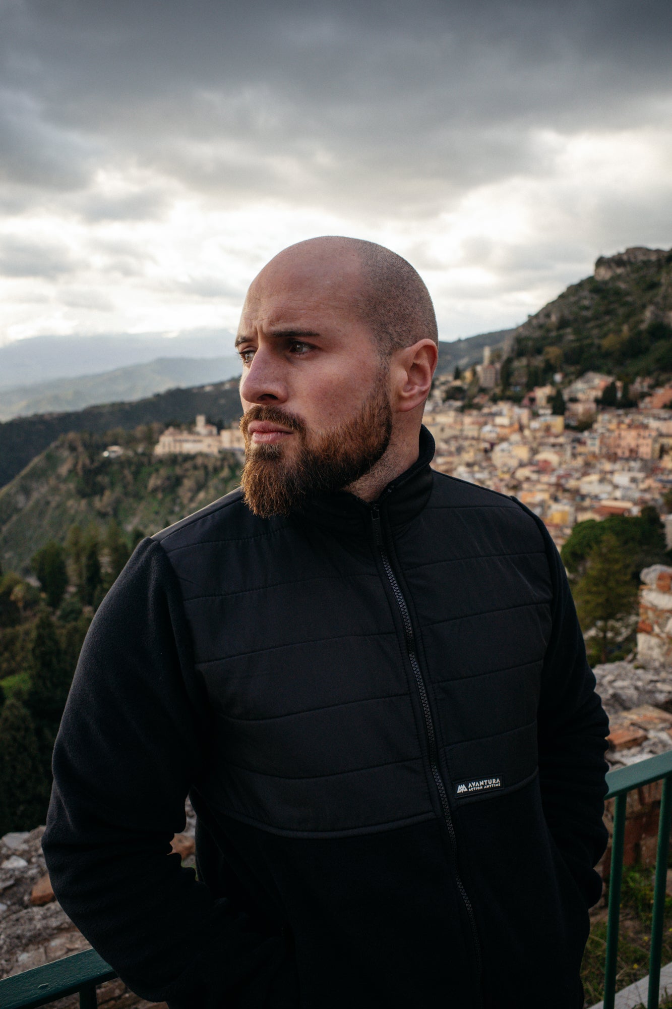 Front view of black fleece jacket with woven AVANTURA label on left chest
