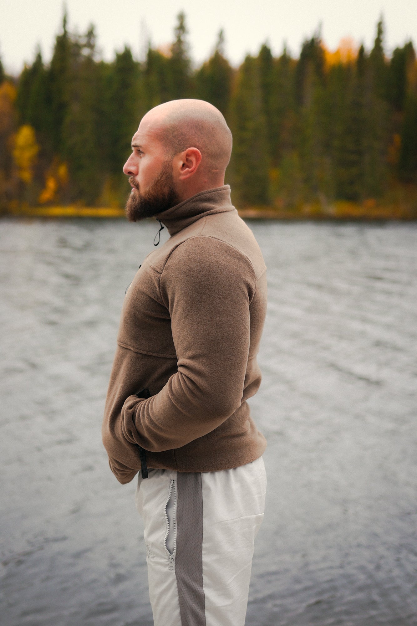 Side profile fit of brown fleece jacket with hands in pockets