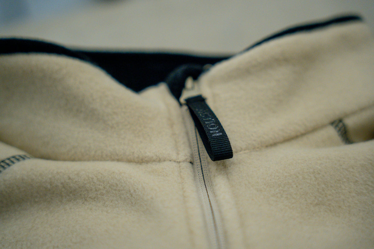 Macro of zipper with ACTION ANYTIME zipper tape on half-zip pullover