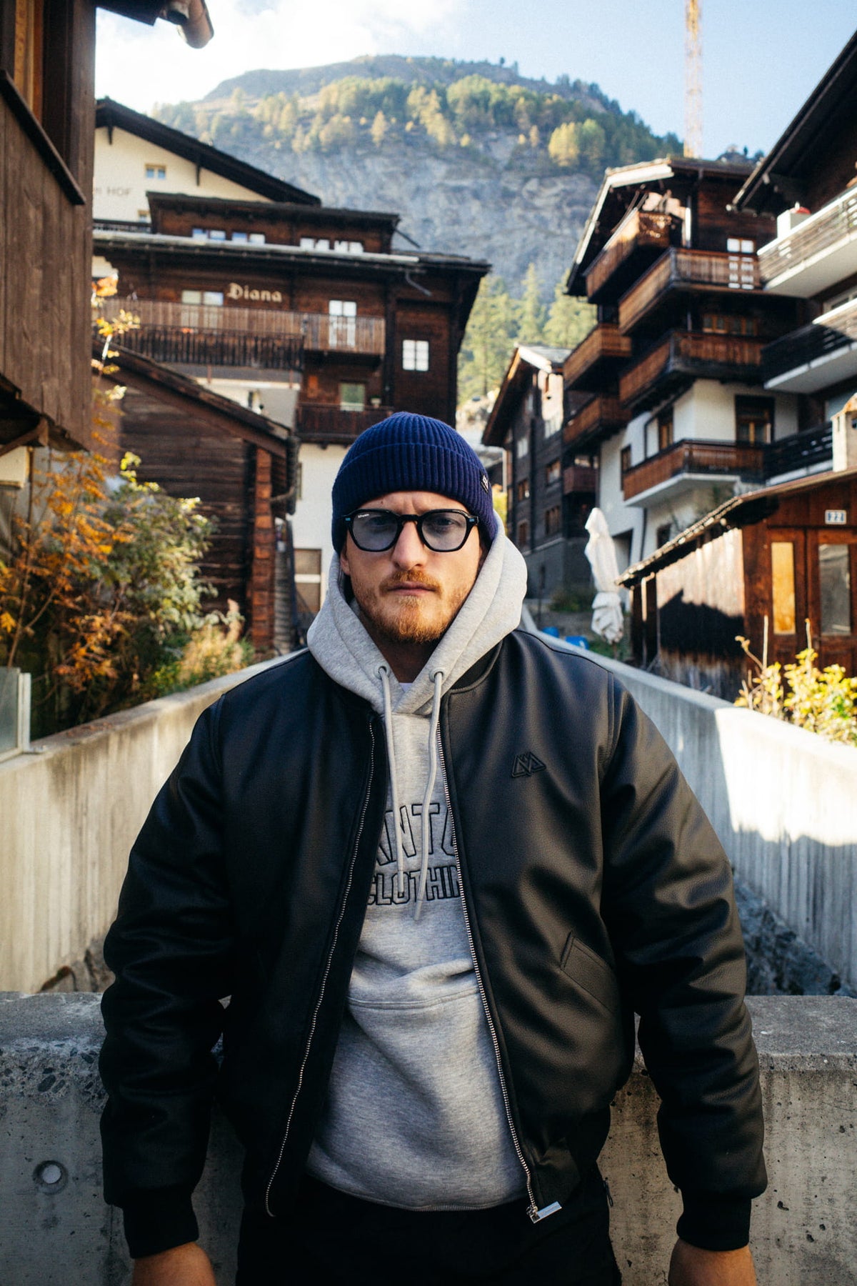 Black bomber jacket with chest logo, winter look
