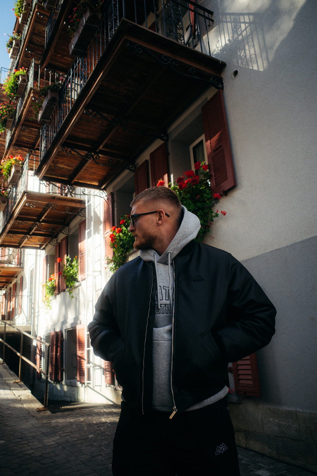 Black leather jacket side view against urban background
