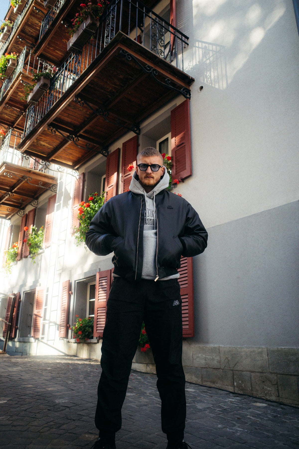 Black bomber jacket paired with black pants