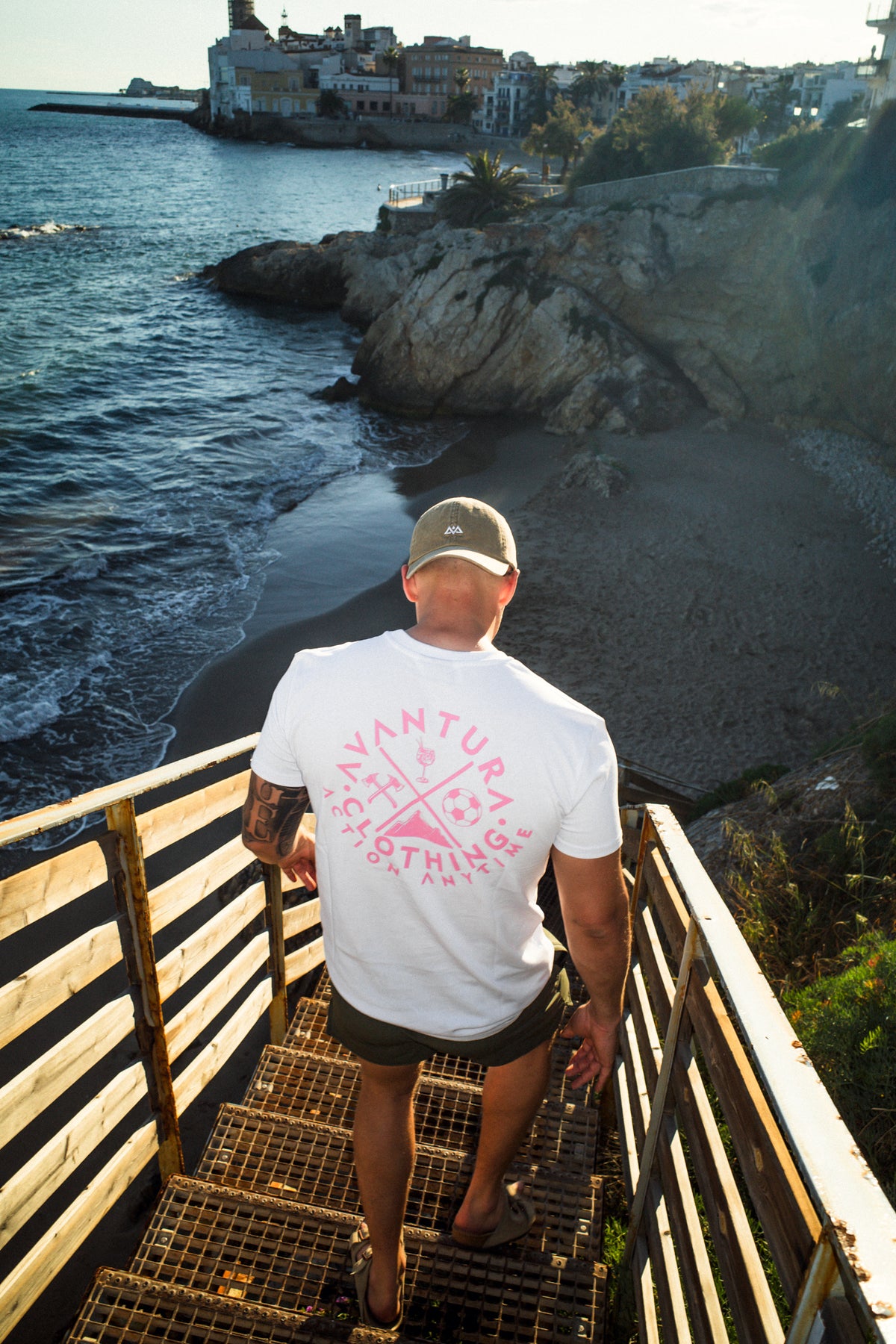 White t-shirt with large pink back graphic print worn walking down stairs
