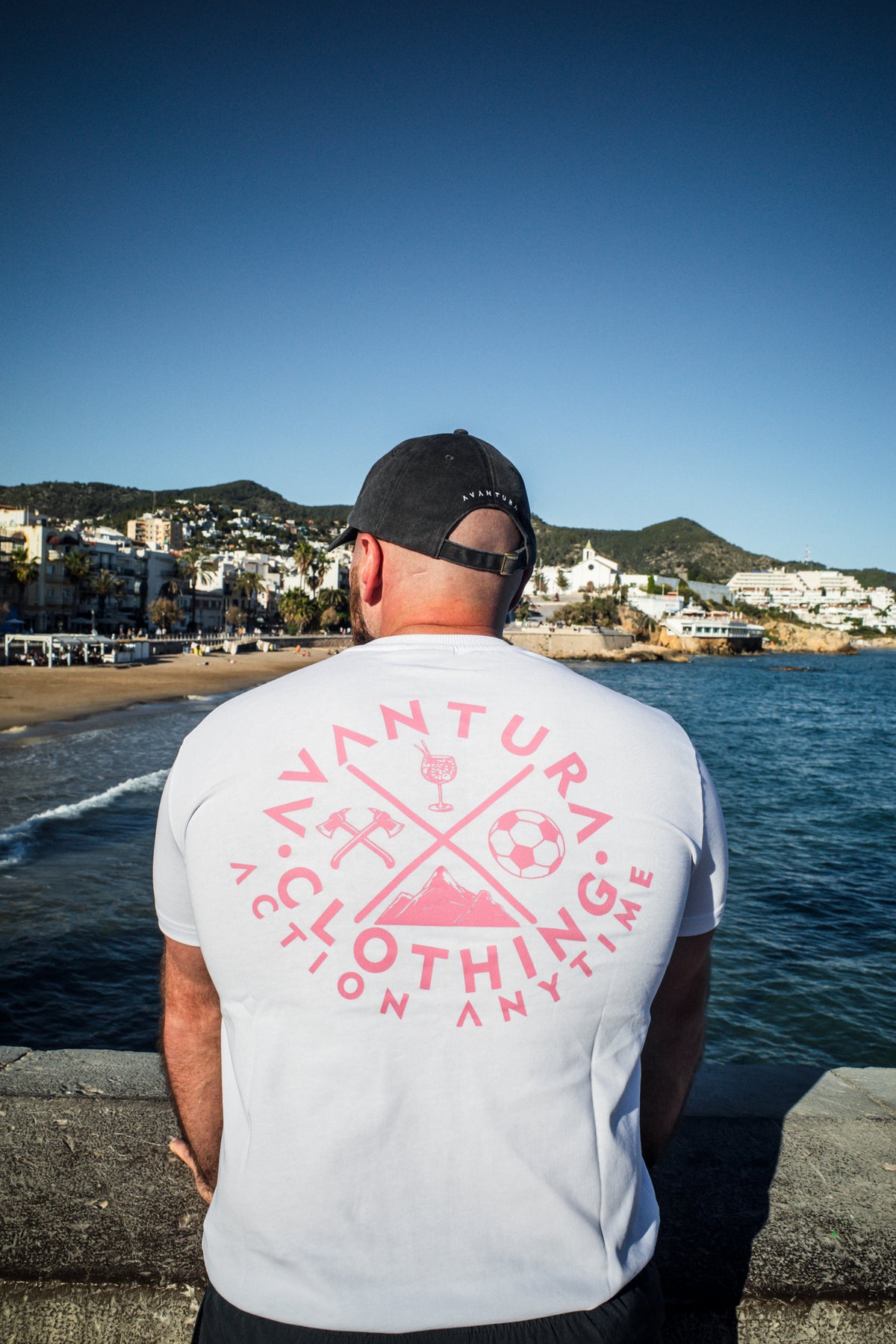 White lifestyle t-shirt with large pink circular back print featuring icons and text