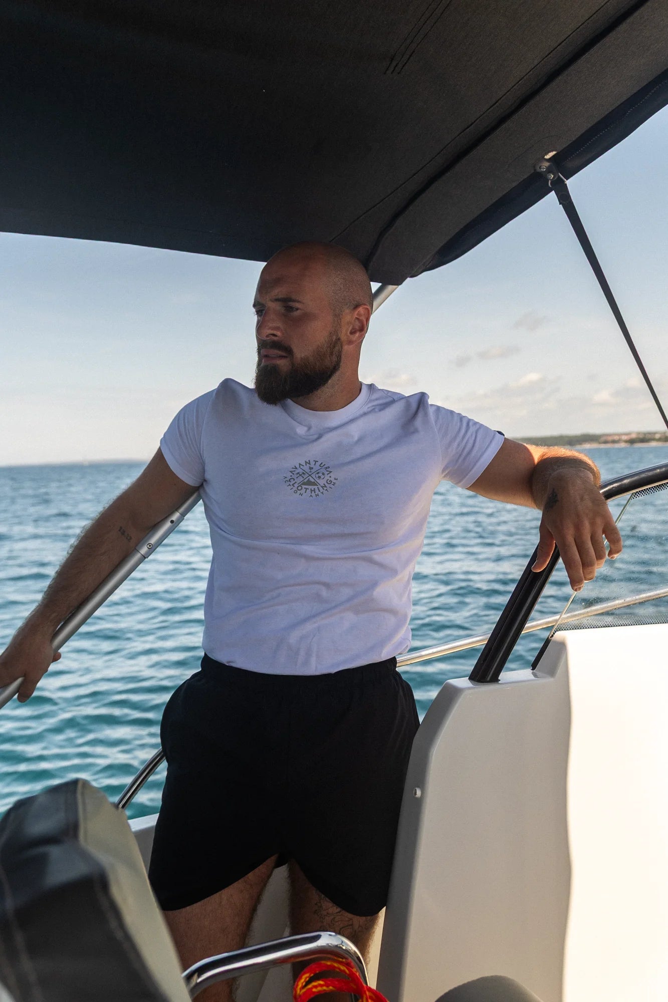 Front view of white t-shirt showing small centered circular chest logo
