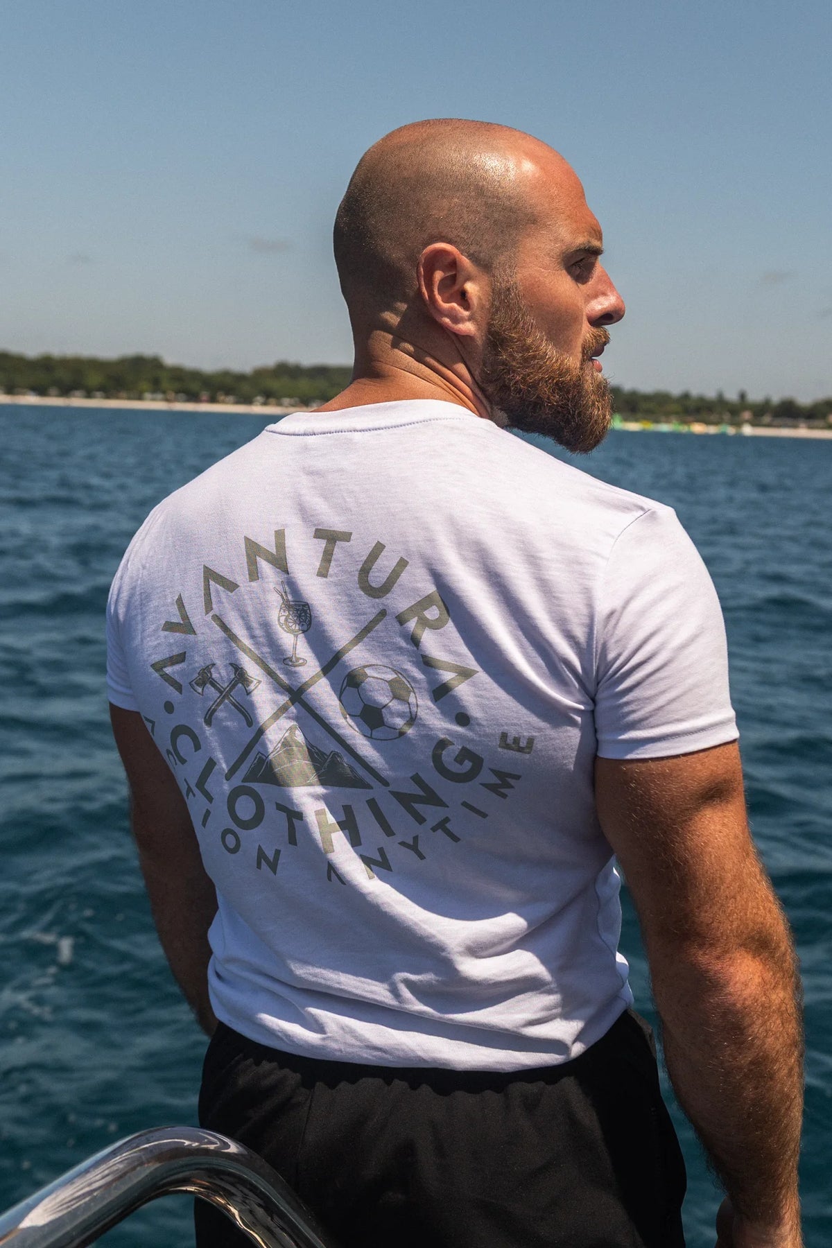 Rear view of white t-shirt with circular back print standing on boat