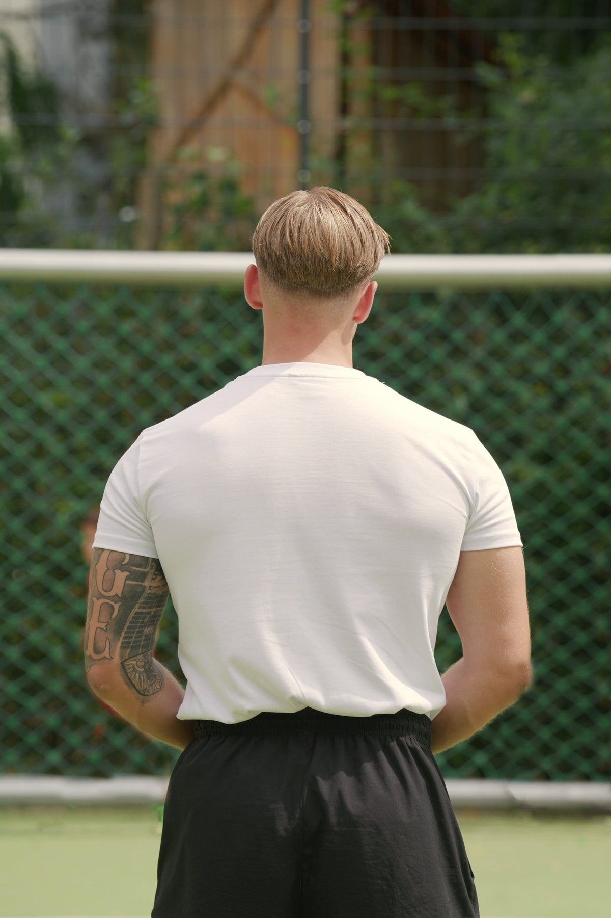 Plain white crew-neck T-shirt back view showing smooth fit