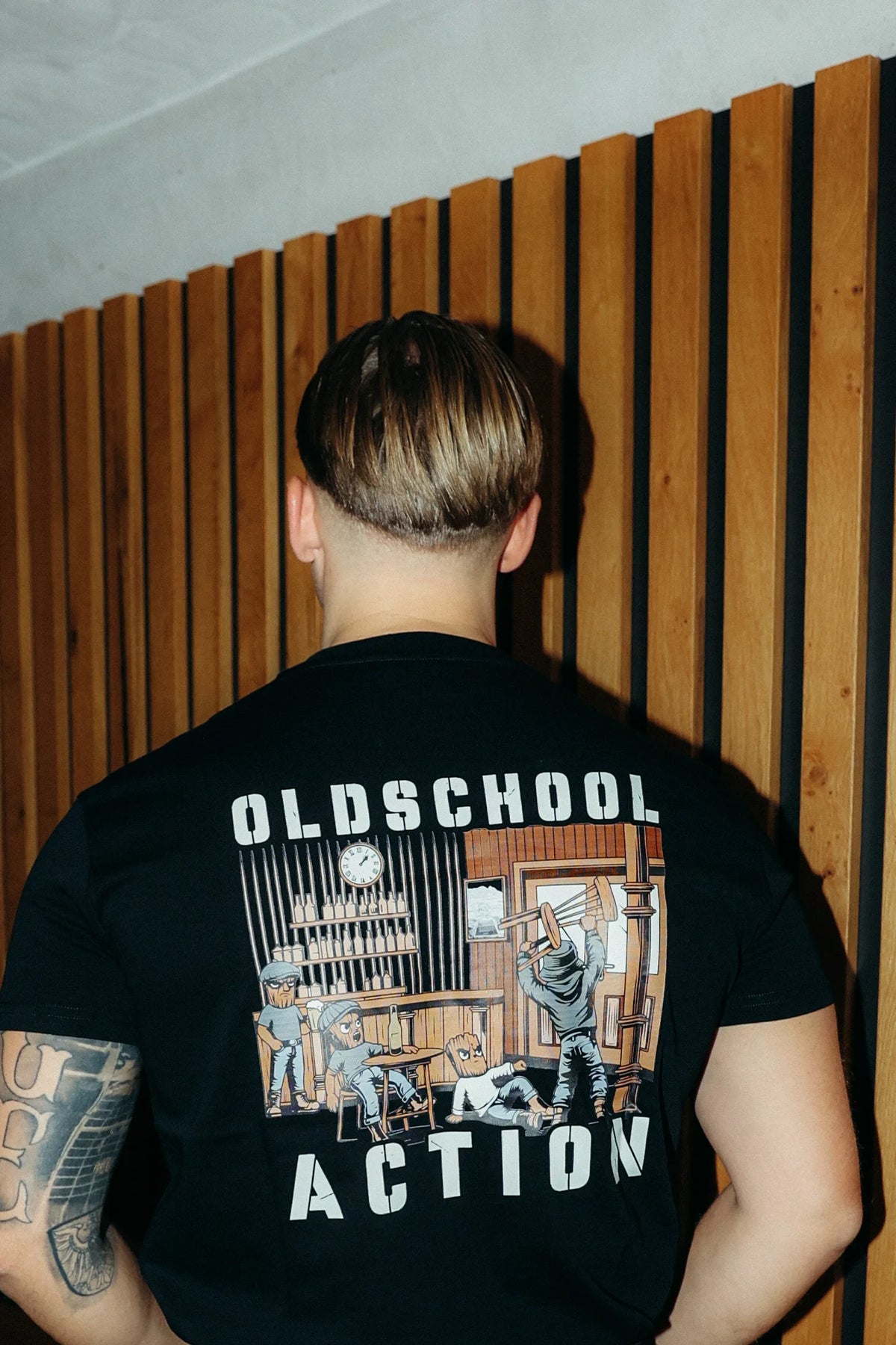 Back view of black T-shirt with large OLDSCHOOL ACTION back print