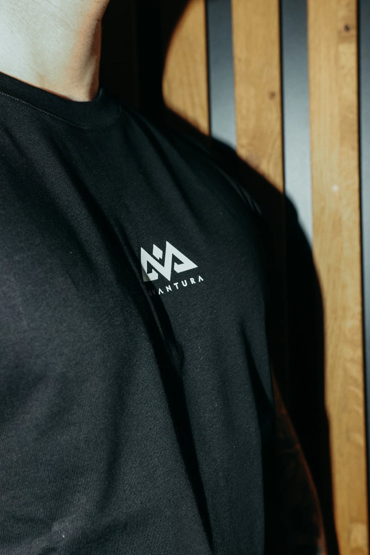 Black T-shirt with white Avantura logo print on the chest