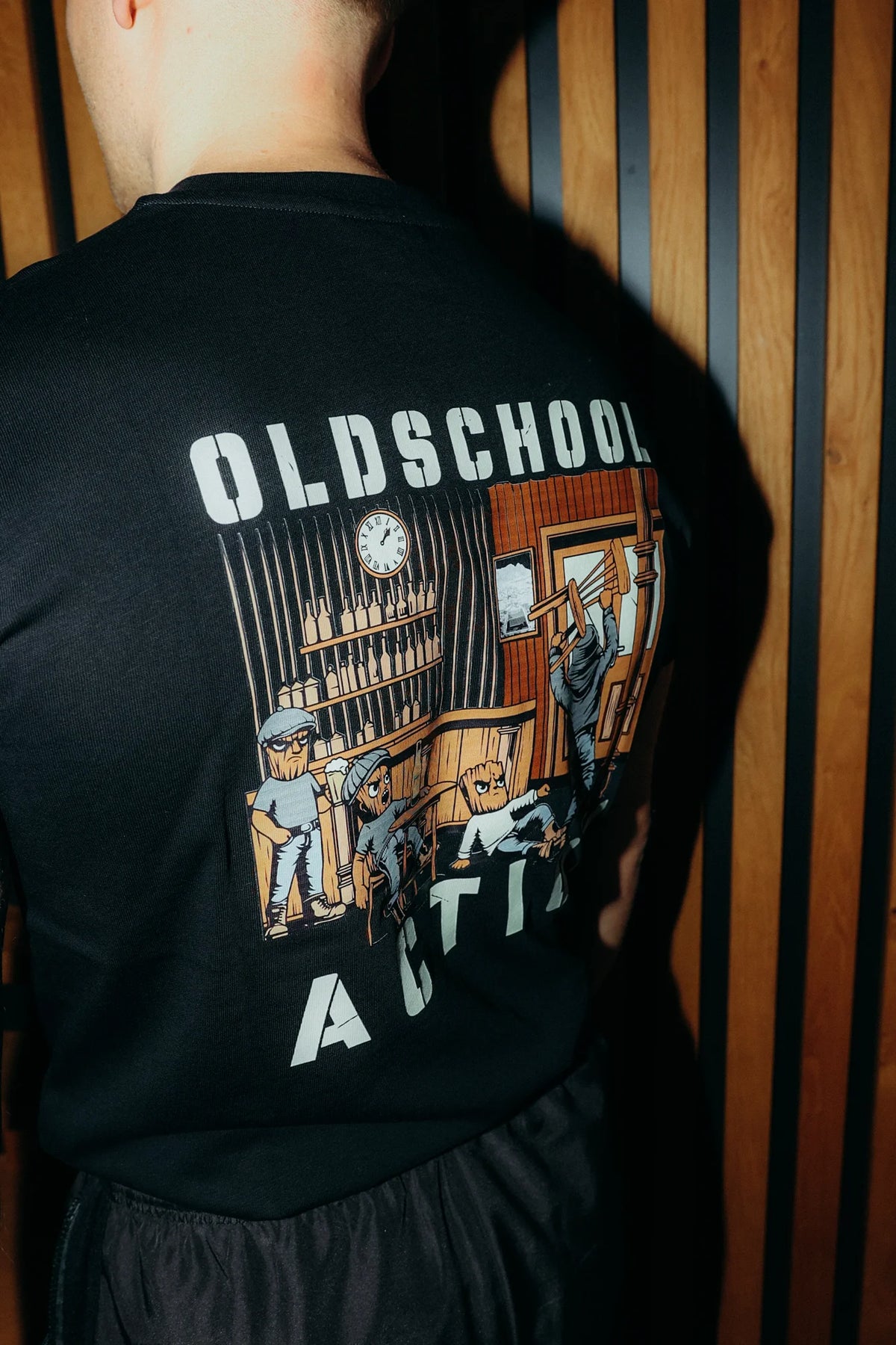 Close-up of illustrated bar scene on the black T-shirt