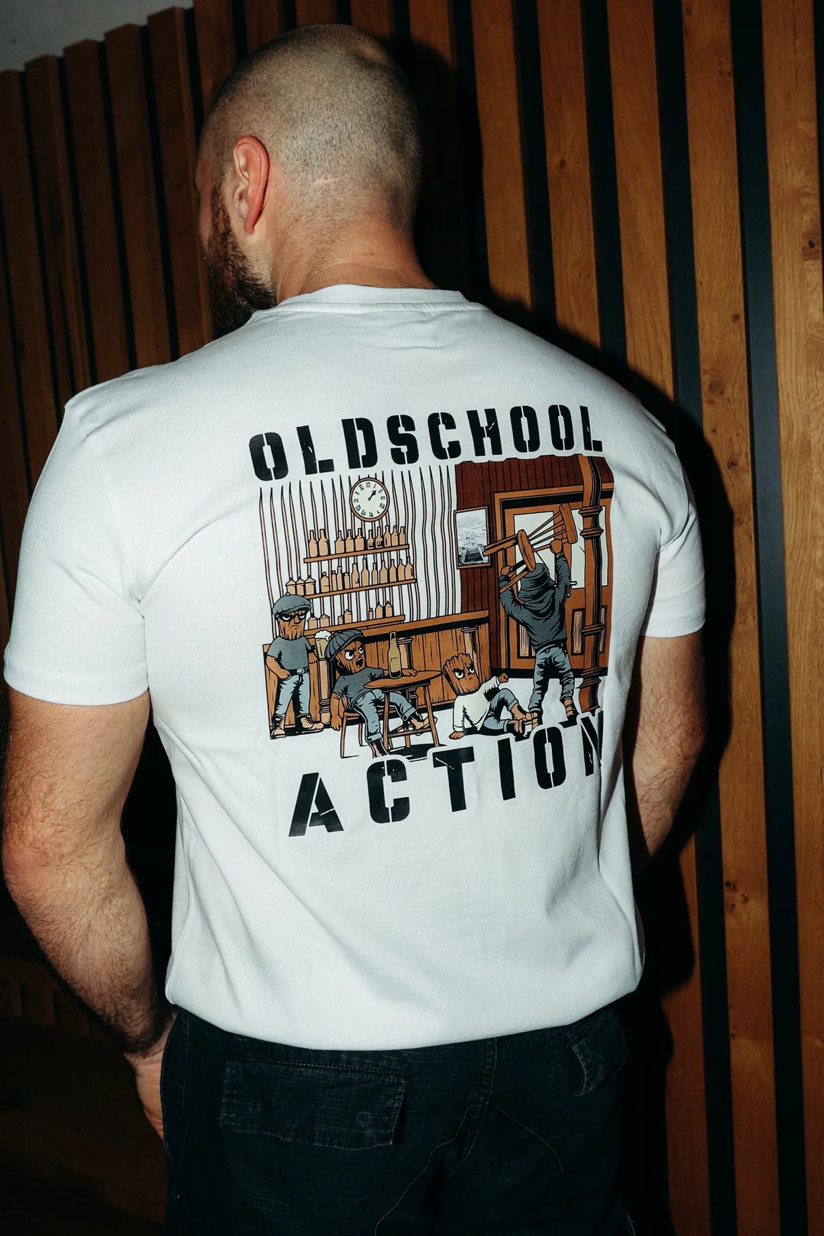 Man wearing white T-shirt showing full vintage bar scene back design