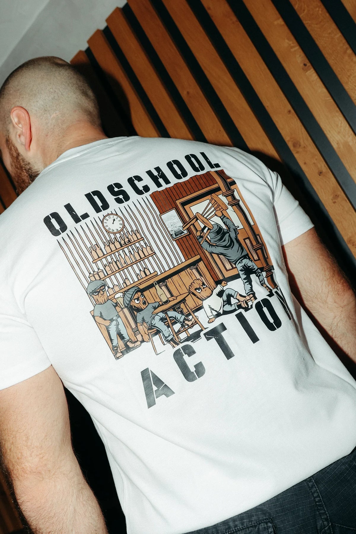 White T-shirt featuring large oldschool action back print graphic