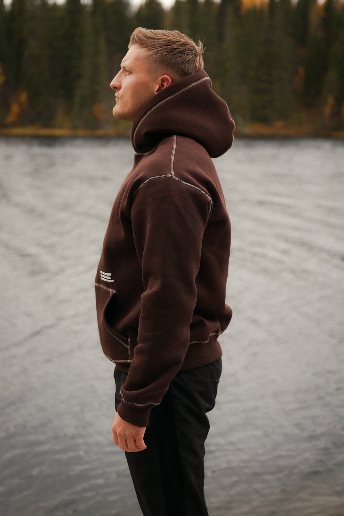 Side view of brown hoodie with prominent hood trim and saddlebag-style stitching