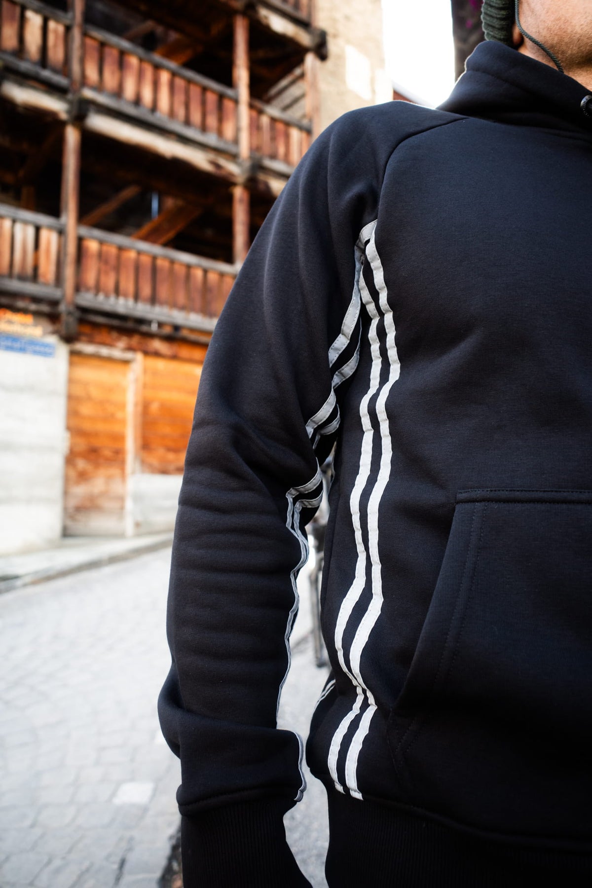 Close-up of reflective stripes on black Avantura hoodie