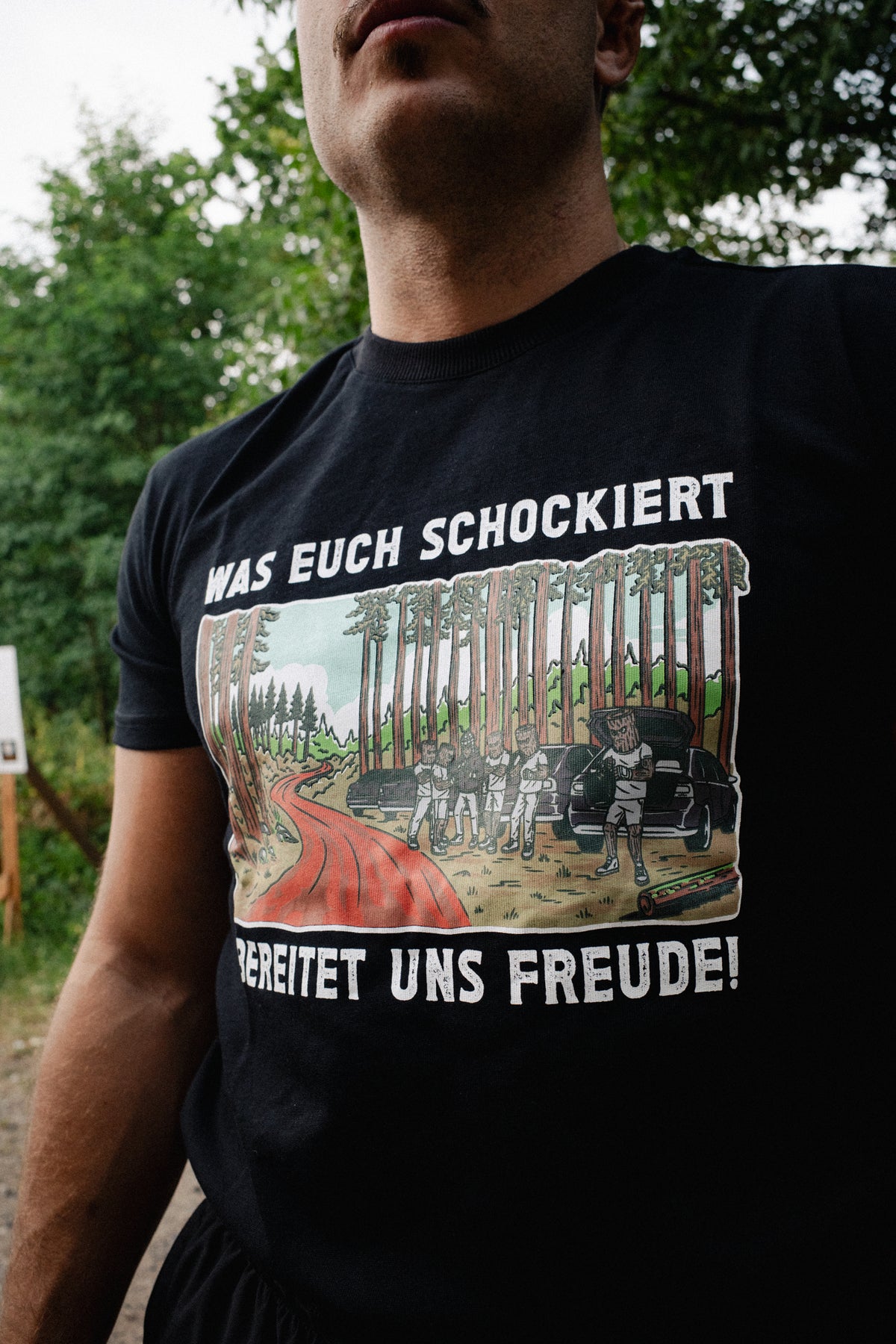 Smooth fit black T-shirt with bold white slogan and illustrated forest design