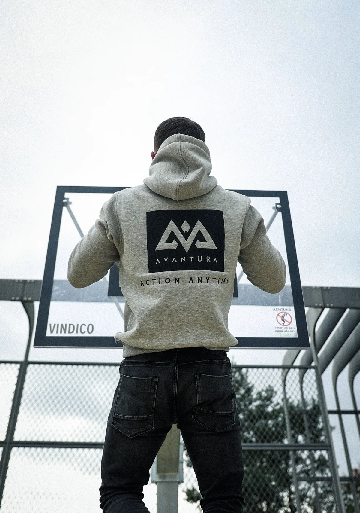 Back view of heather grey hoodie with large black square graphic and white mountain logo