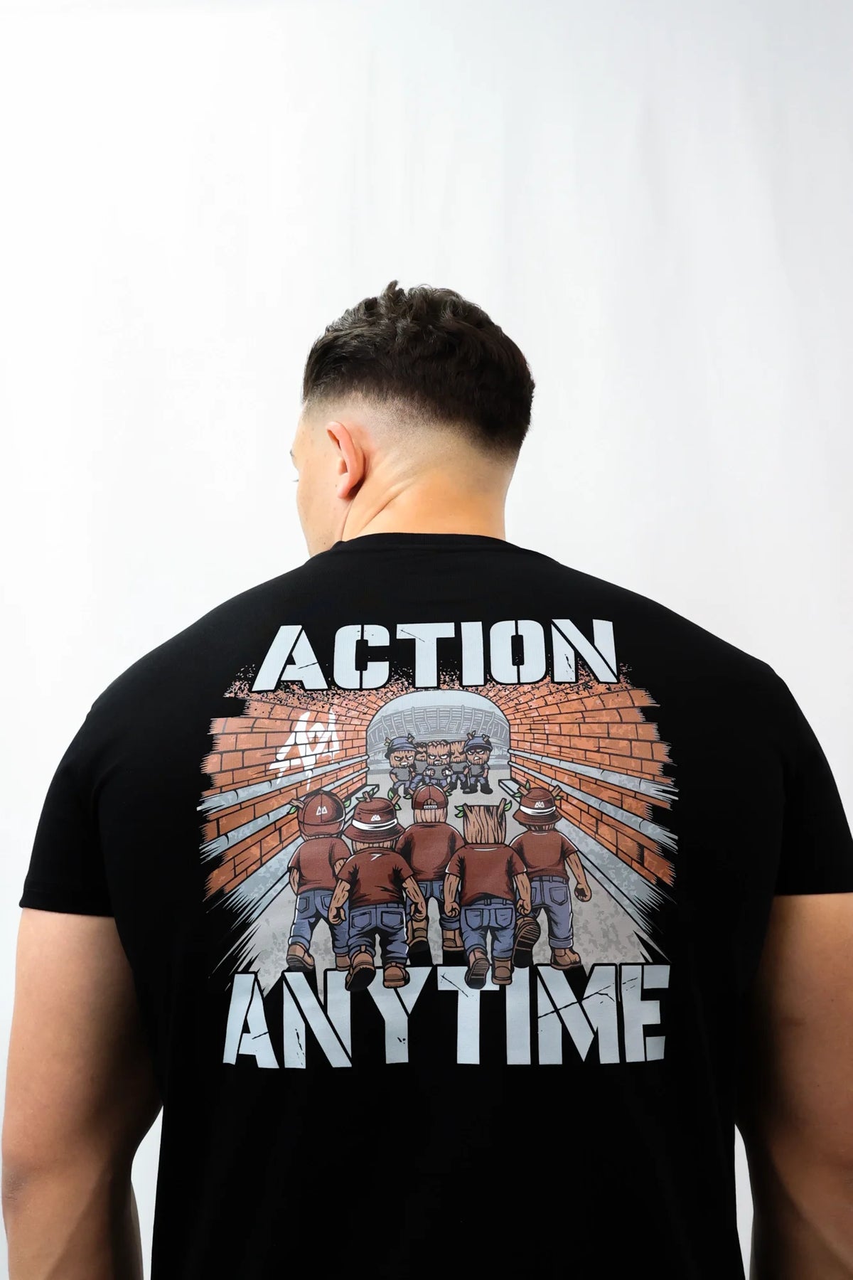 Back view of T-shirt: Action Anytime print with tunnel graphic on white