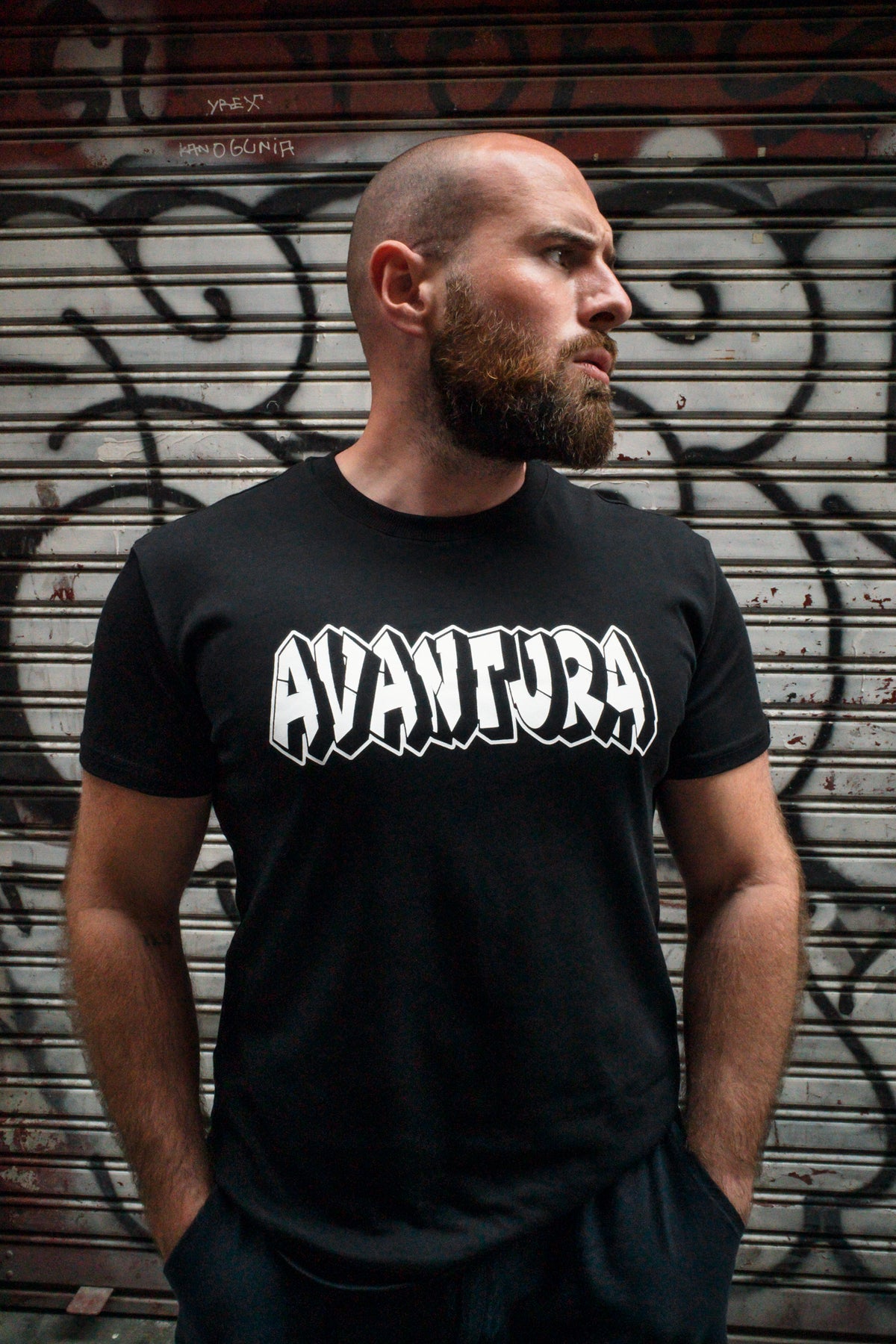Black short-sleeve T-shirt with centered white AVANTURA graffiti logo