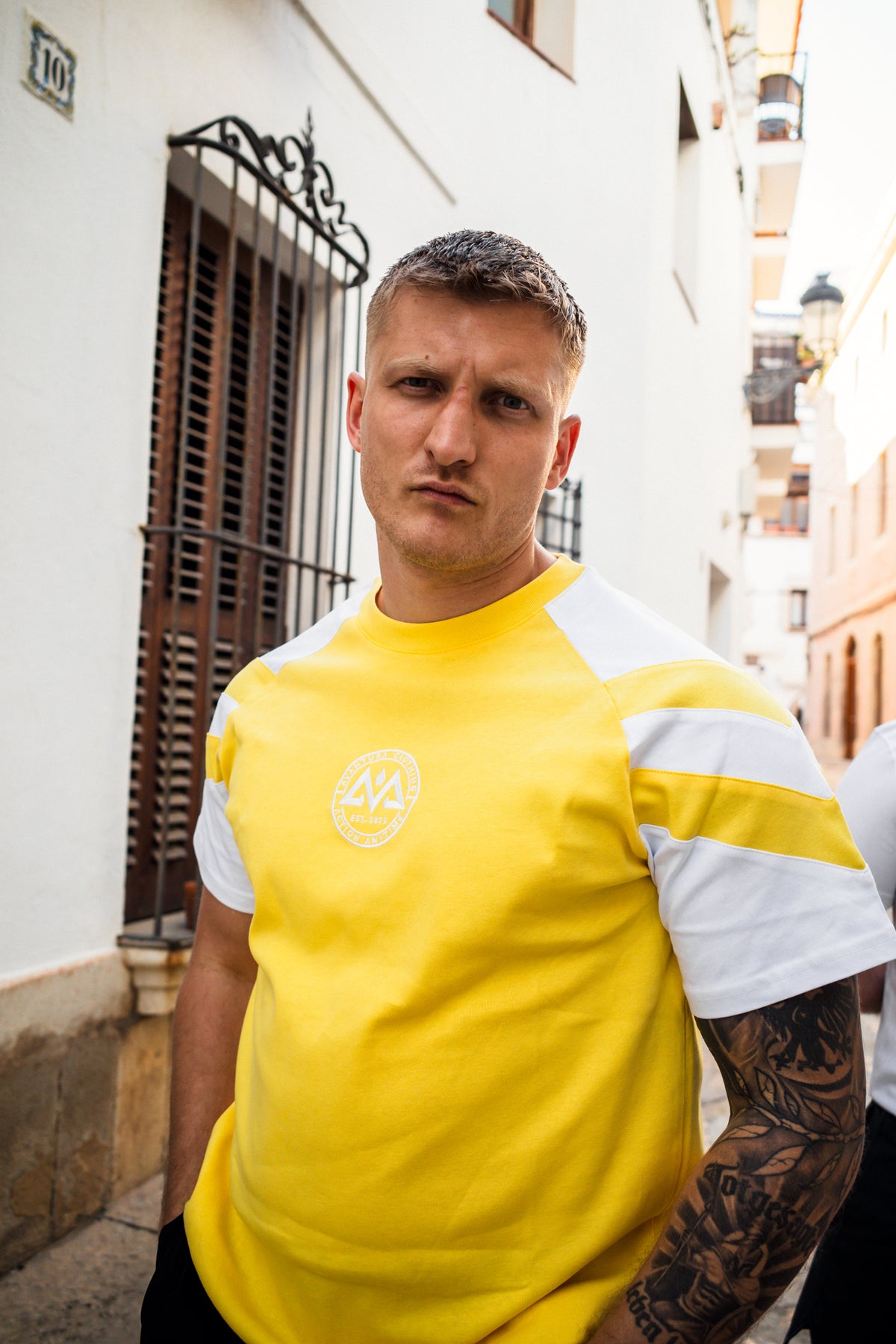 Yellow t-shirt logo and sleeve stripe detail