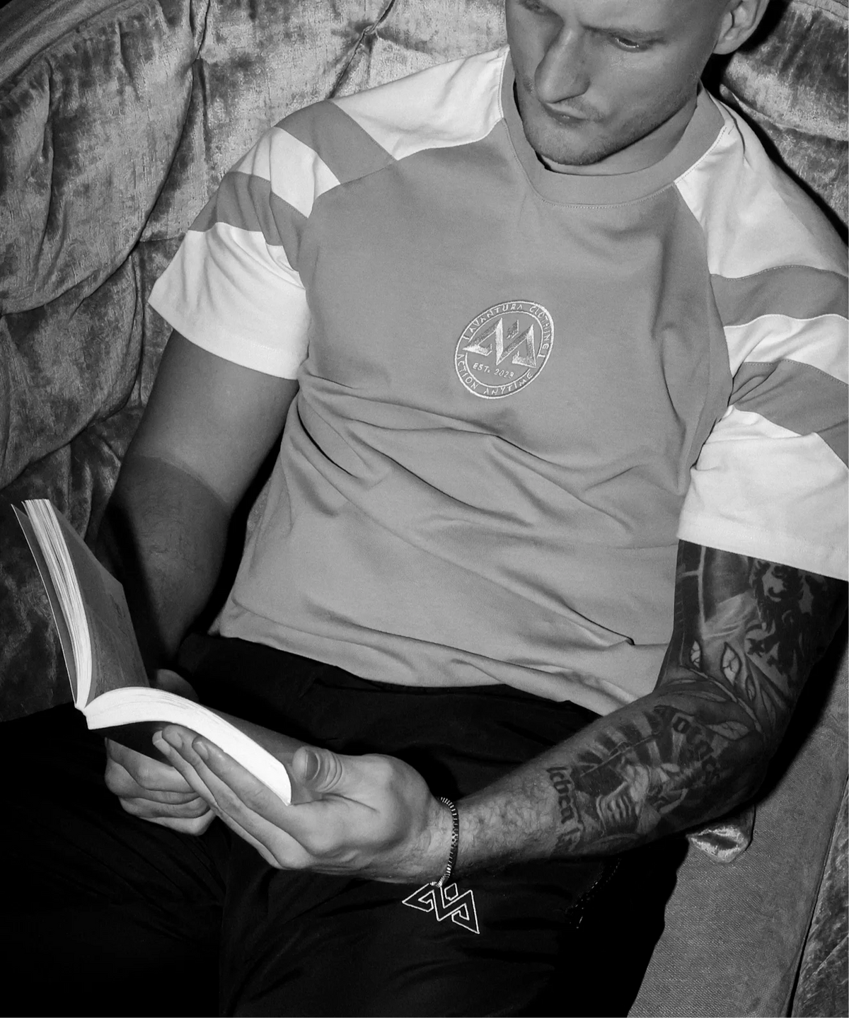 Close-up of gray striped t-shirt with logo embroidery