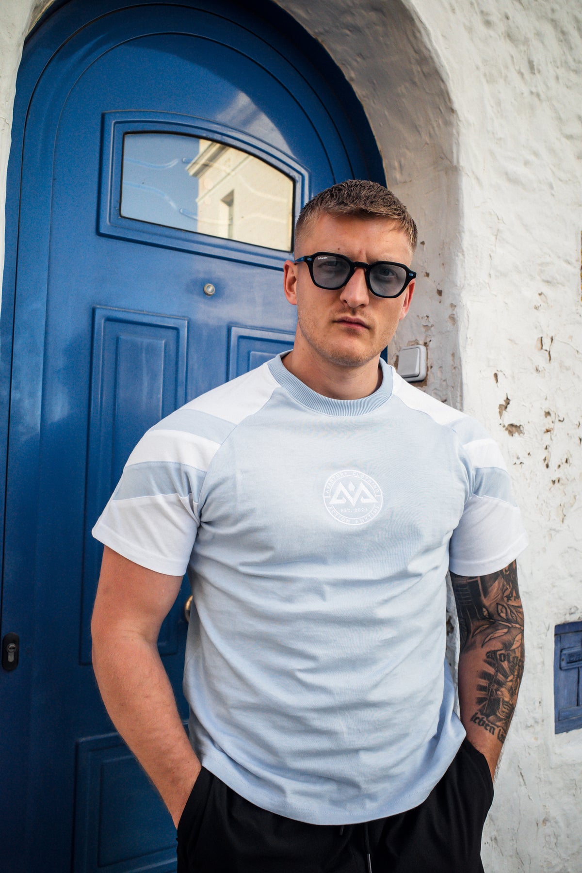 Relaxed fit light blue striped t-shirt with circular chest logo detail