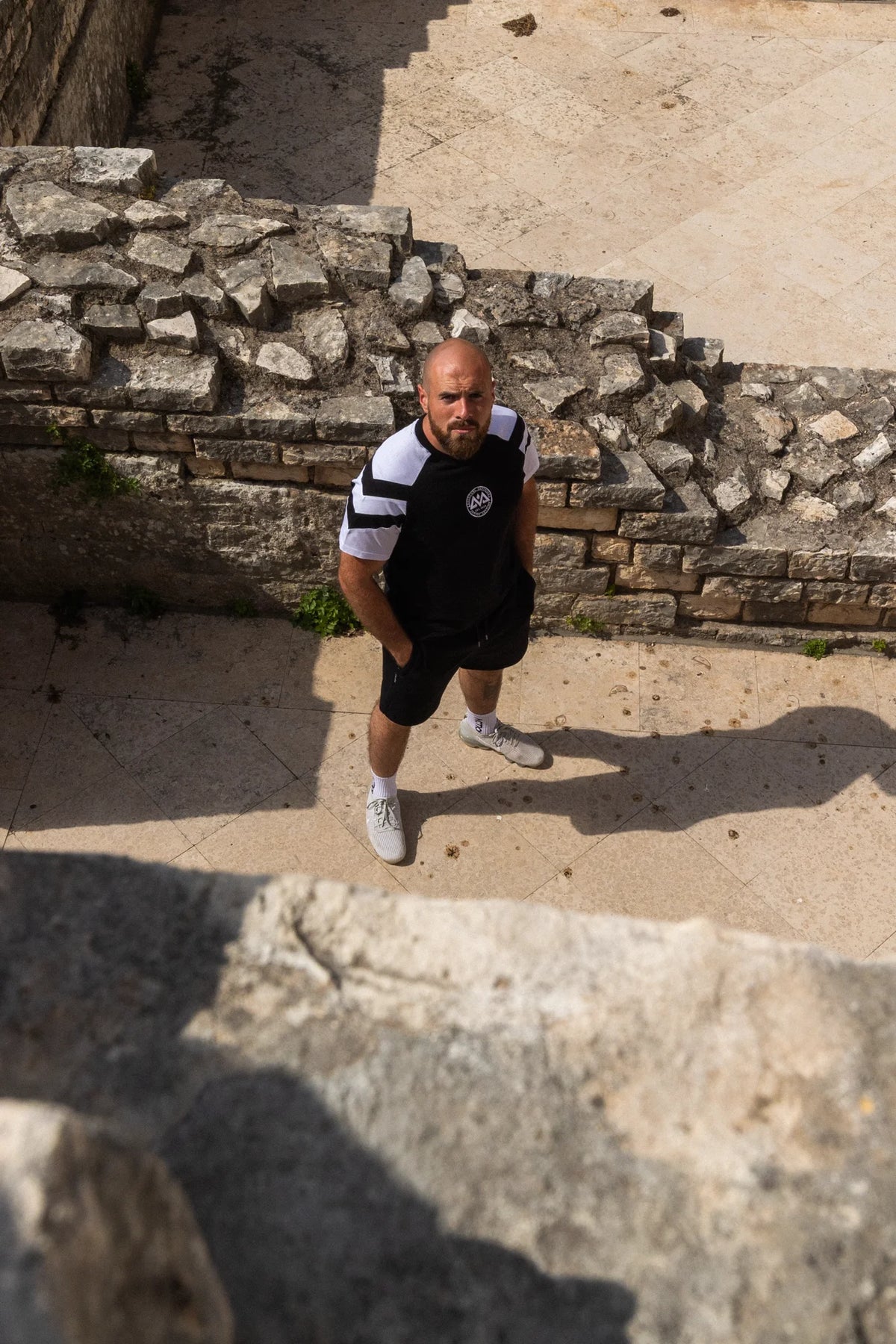Black T-shirt with white stripe, loose fit, full body view