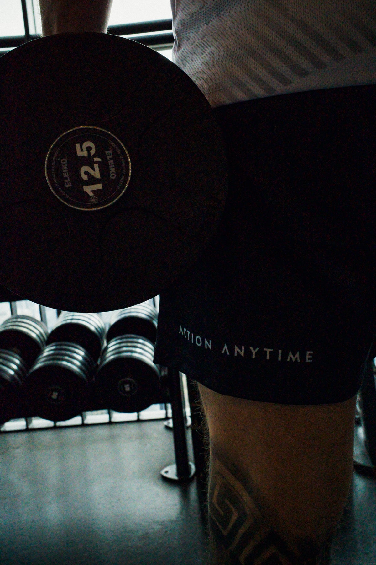 Side profile of black athletic shorts in gym setting